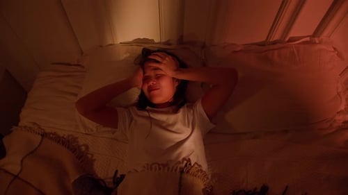 Young Woman Awake at Night in Bed