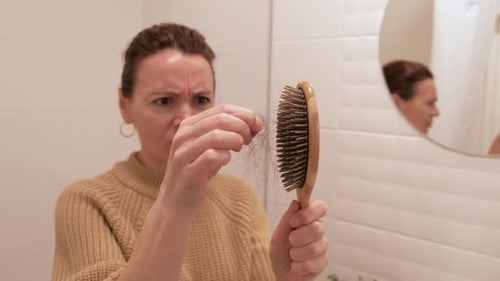 Woman Horrified By the Hair on Her Brush