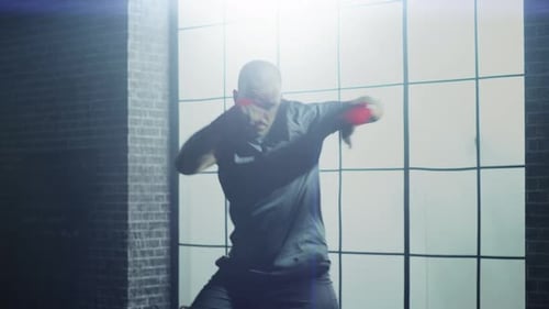 Strong and Handsome Male Boxer is Working Out in a Loft Gym with Motivational Posters on Walls. Mas