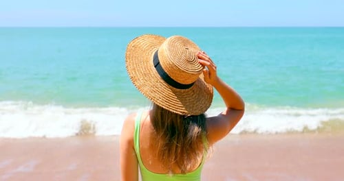 Female Traveler Enjoys a Relaxing Sunbath on a Tropical Beach Turquoise Ocean on Background