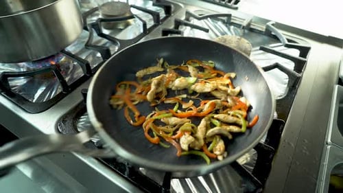 Chef Prepares Chicken with Vegetables in a Pan in a Restaurant 4K