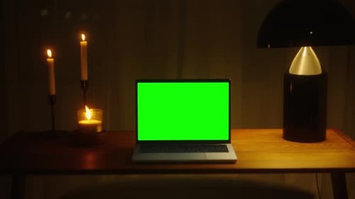 Cinematic Visuals Elevate Your Video with Shots of a Green Screen Laptop in a Festive Candlelit