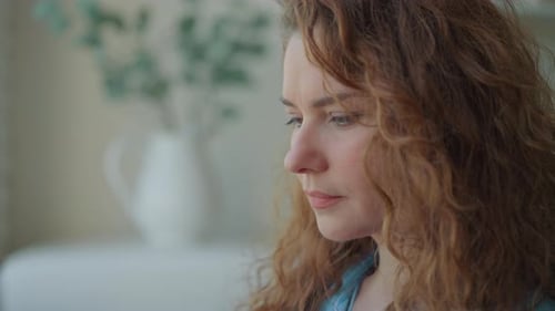 Adult Woman with Auburn Curls in Interior Setting