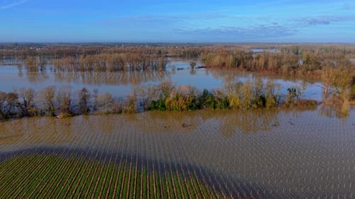 Aerial view of floodwater reflecting the blue sky, Rions, France.