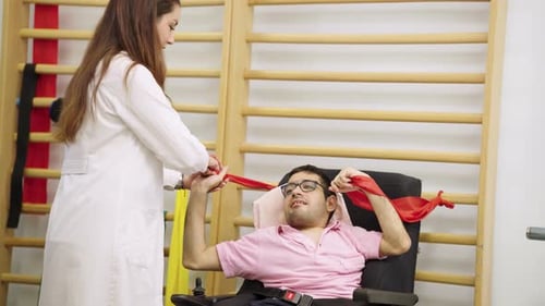 Man Exercising with Therapist Using Resistance Band