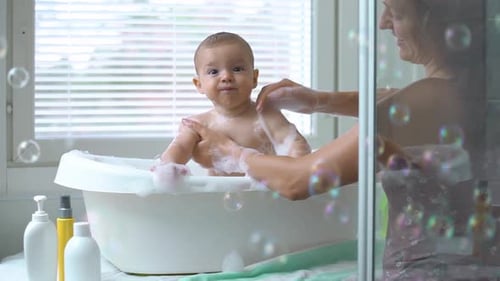 Baby Laughing During Bath Time with Parent