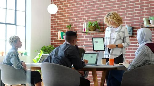 Diverse Team Collaborates in Modern Office Meeting