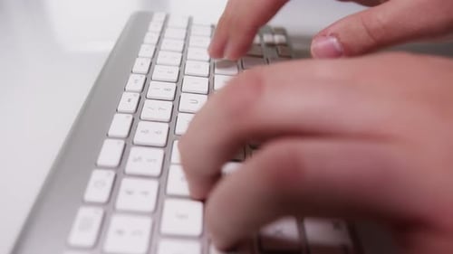 Close-up of Fingers Typing Something on White Keyboard