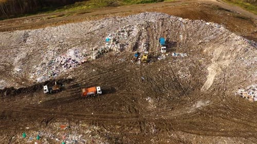 Garbage Trucks Unload Household Waste at the Landfill