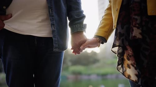 Close Up Portrait of Unrecognizable Mature Couple Holding Hands Standing Outdoor