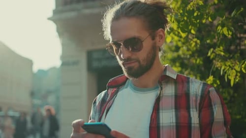 Young Stylish Young Man with Sunglasses Standing Using Phone Street Texting Casual Clothing Shirt