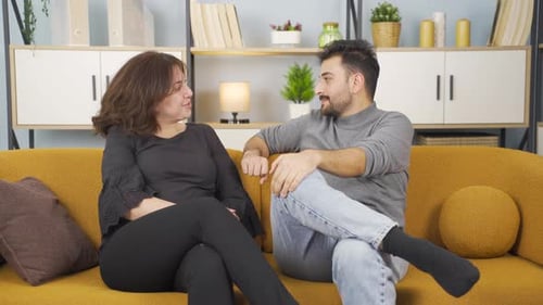 Couple Chatting Comfortably on Sofa at Home