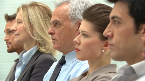 Businesspeople in a Row at Business Conference. Portrait of Mature Businessman Looking