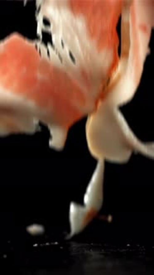 Fresh Bacon Falling on Black Background Filmed on a Highspeed Camera at 1000 Fps