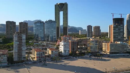 Aerial drone view of the buildings along the coastline and the sea in Benidorm, Spain in daylight