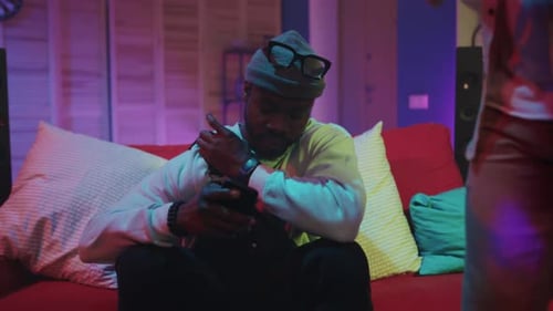 Young Man on Phone at a House Party