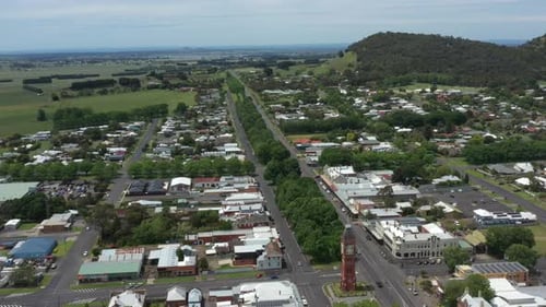 Aerial Around Town Historical Clocktower With Mountain In Background