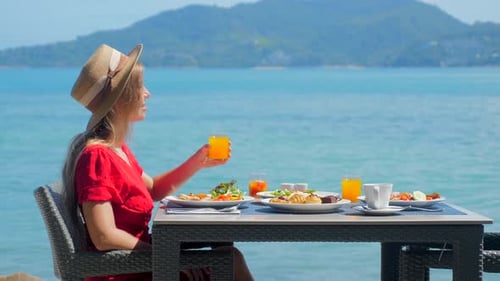 Woman Relaxing in Luxury Hotel Enjoy Breakfast with Sea View