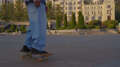 Young Adult Skateboarding in Urban Park on Sunny Day