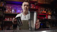 Bartender Preparing Cocktail at Night in Urban Bar