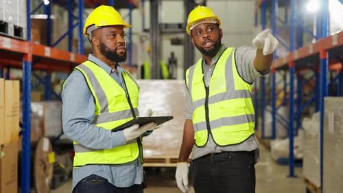 Warehouse Workers Checking and Controlling Boxes in Warehouse