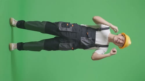 Full Body Of Asian Man Worker Wearing Goggles And Safety Helmet Singing And Dancing On Green Screen
