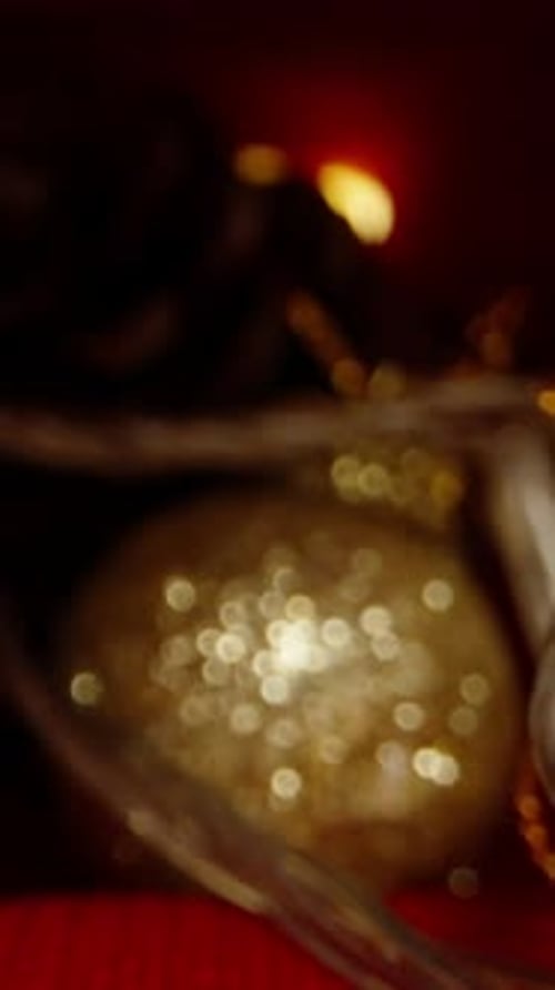 Vertical video. Hidden in Santa's red hat are decorations and gifts, candles on the table, and lante