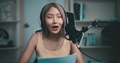 Woman Broadcasting with Microphone and Headphones at Home