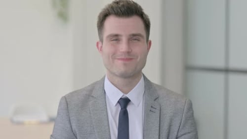 Smiling Man Wearing Business Suit Looking at Camera