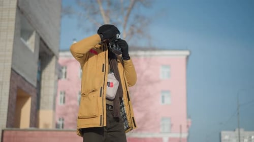 Man with Camera Outdoors on Cold, Bright Day