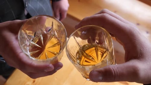 Whiskey Toast Between Friends in Home Setting