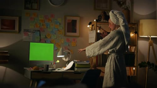 Emotionale Frau im Bademantel erklärt nachts aus der Ferne auf einem Greenscreen-Computer