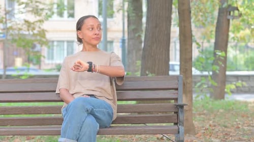 Woman Checking Time on Watch in Green Park