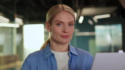 Smiling Woman Working At Office Desk