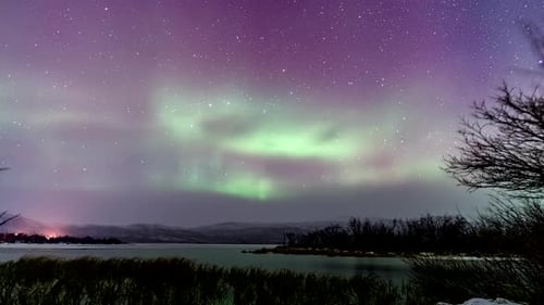 Starry Night Skies With Colorful Aurora Borealis Over The River In Finland. - time lapse shot