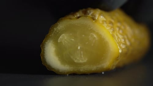 Pickle Being Sliced With Sharp Knife