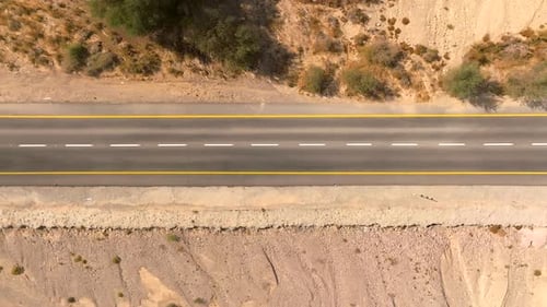 Empty Desert highway mountain road with Blue cloudy sky