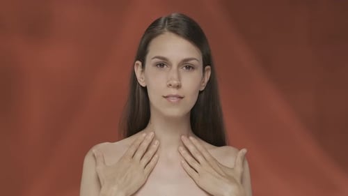 A Woman Demonstrates Her Perfect Skin and Regular Facial Features Portrait of a Seminude Woman on a