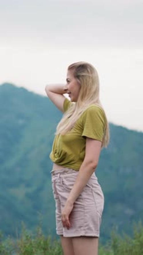 Smiling Blonde Woman Amazed of Picturesque Mountains View