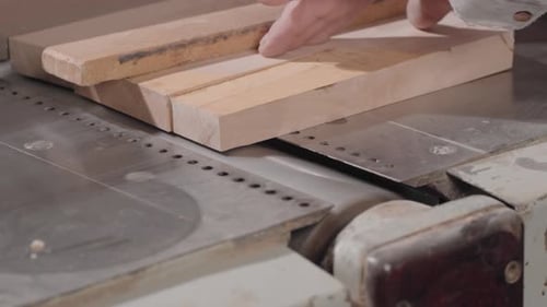 A Man Carpenter or Joiner Works and Uses a Grinding Machine to Polishing Wooden Planks Surface A