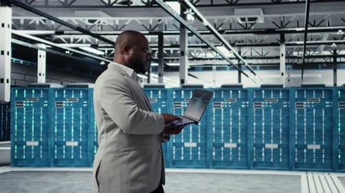 Server Farm IT Specialist Using Laptop to Improve Deep Learning AI Systems