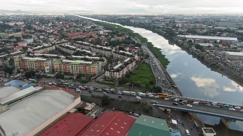 Aerial scenic shot view of dense cityscape, forward view off to the traffic bridge and roadway throu