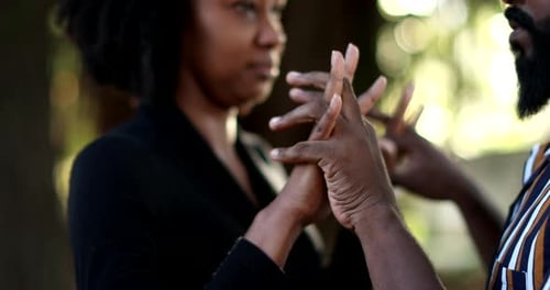 Intimate Couple Holding Hands and Kissing Outdoors