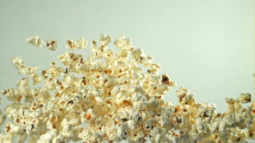 Popcorn Flies Up and Falls Down On a Light Background Filmed on a Highspeed Camera at 1000 Fps