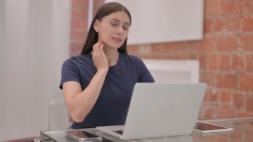 Young Woman Working on Laptop at Glass Desk