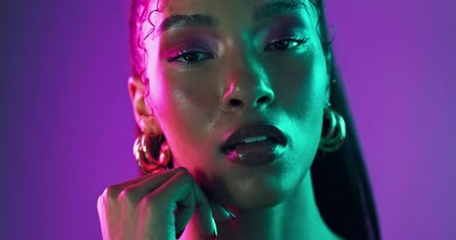 Neon lights, cosmetics and face of woman with glow in studio with beauty
