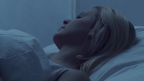 Woman Sleeping Peacefully at Night in Bedroom