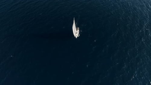 Cinematic Shot of a White Yacht Against the Background of a Deep Blue Calm Sea Aerial View 4 k