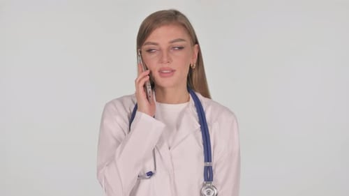 Young Woman Doctor Talking on Smartphone