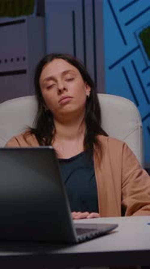 Tired Overworkes Businesswoman Sleeping in Startup Company Office on Desk Chair